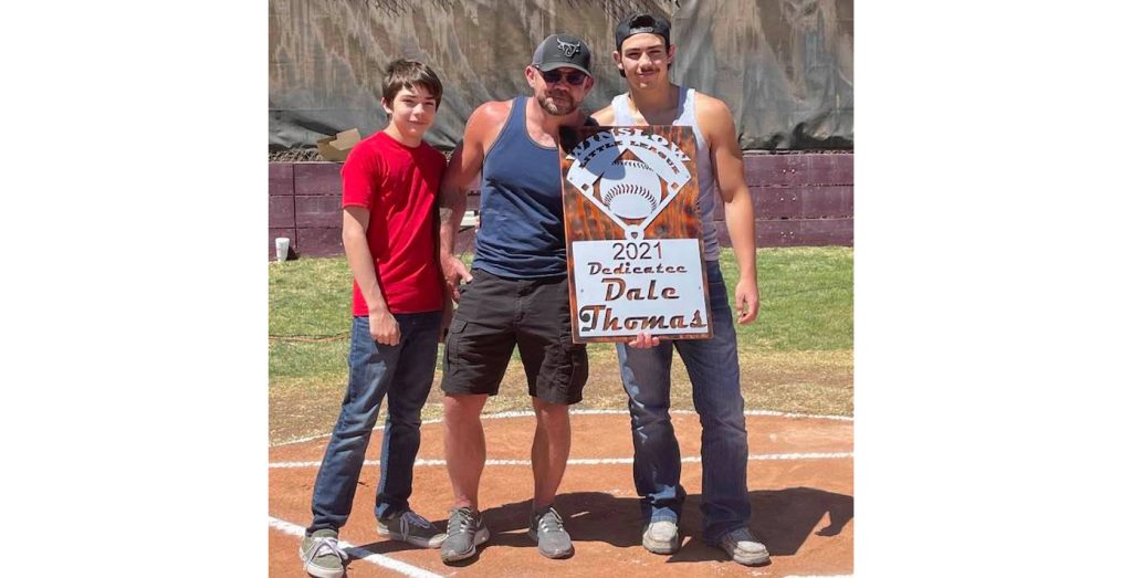 Photo courtesy of Winslow Little LeagueWinslow’s 2021 Little League season is dedicated to Dale Thomas (center). Thomas has been a part of the Winslow Little League for over 20 years and threw out the first pitch on Saturday. Also pictured are Thomas’ kids Connor (left) and Gage (right).