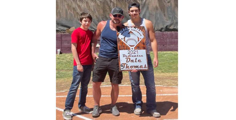 Photo courtesy of Winslow Little LeagueWinslow’s 2021 Little League season is dedicated to Dale Thomas (center). Thomas has been a part of the Winslow Little League for over 20 years and threw out the first pitch on Saturday. Also pictured are Thomas’ kids Connor (left) and Gage (right).