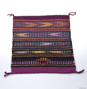 This piece, “No COVID-19 Blues” is a weaving on display by artist Tamerra Martin.
