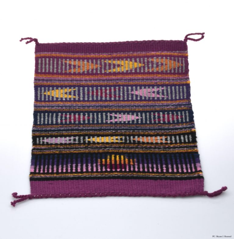 This piece, “No COVID-19 Blues” is a weaving on display by artist Tamerra Martin.