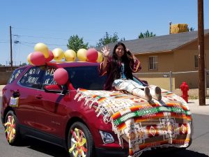 Photo by L. ParsonsWinslow High School senior Autumn Freddie wore traditional dress as she waved to the crowd during the graduation parade last week.