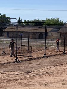 Photos by Magan MaestasKids in Little League will have even more baseball fun at Barrow Field Holbrook with the addition of a batting cage donated by and installed by Justin Maestas. Maestas, pictured working the dirt where the cage is and playing with his son Justin, is a lifelong resident of Holbrook and a big supporter of local Little League.
