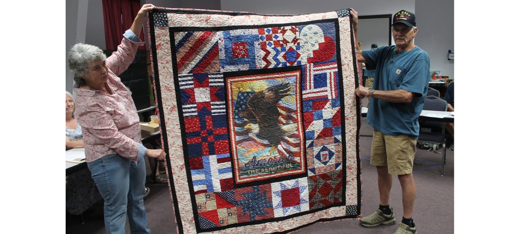 Photo by Linda KorVietnam veteran Bruce Askey (right) was presented with a veteran’s quilt created by the Dusty Desert Quilt Guild last week at the Holbrook Public Library. The guild members create a number of quilts each year to pay honor to veterans in the community who made great sacrifices by serving their country and preserving freedom. Assisting with presenting the quilt is Judy McCauley (left).