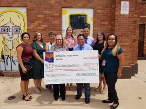 Photo by L. ParsonsThe Arizona Department of Corrections, Rehabilitation and Reentry Winslow Complex donated over $8,072.79 to the Winslow Unified School District last week. The money, raised through inmate and employee fundraisers throughout the year, will be shared amongst the five Winslow school sites. DOC staff, school administrators and principals were on hand to receive the check including (front row, left to right) DOC Administrative Secretary Liz Christiansen, Warden Ramiel Aguilar and DOC Executive Staff Assistant Shelayna Begay, (back row) Amber Martinez of Jefferson Elementary School, Amanda Leonard of Washington Elementary School, Deb Lopez of Winslow Junior High, Larissa Richards of Bonnie Brennan School, Sal Hernandez of Winslow High School and Superintendent Connie Gover.