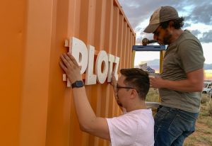 Photo courtesy of Joshua FoerLevi Tafoya (left) and Joshua Foer (right) installing the sign on the building for The Plotz Plot.