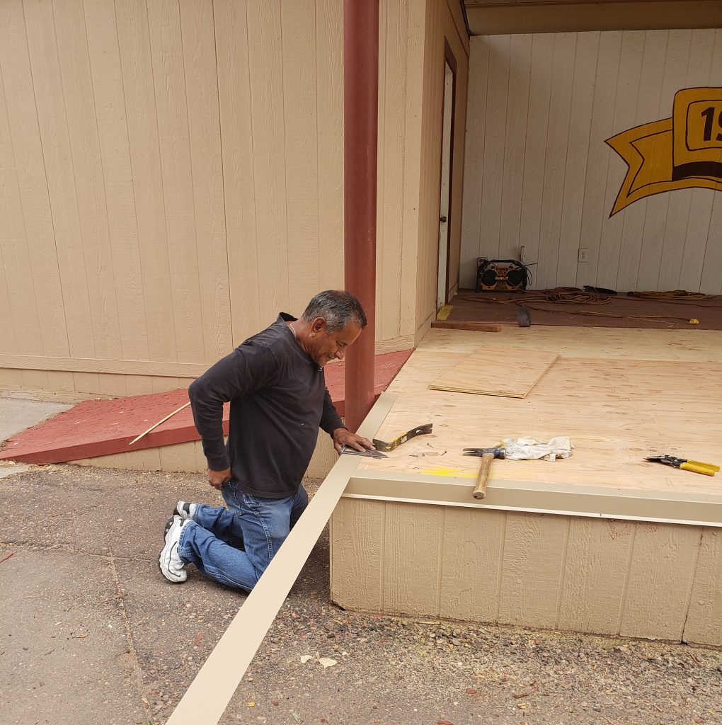 Photo by Annyssa HowertonMichael Sandoval (pictured) is shown redoing the trim on the stage on the Midway in preparation for the upcoming Navajo County Fair.