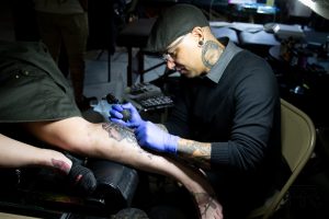 Photo by Ash ReillySierra Vista tattoo artist Michael Otero tattooing at the 2019 Inkfest event in Winslow.