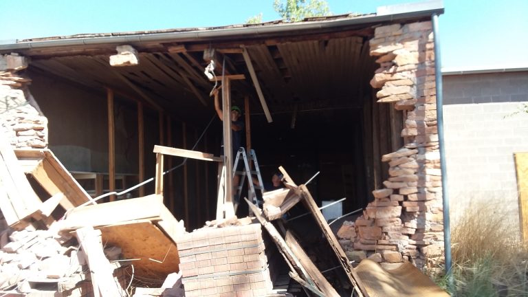 Photo courtesy of the City of HolbrookMike Young with facilities maintenance (left) and Tim Kelley (right) installed temporary bracing until a more permanent solution can be found.