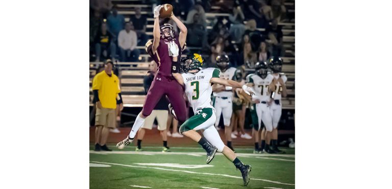 Photo by Richard LarsonBulldog No. 11 Aiden Fallaha jumps high in the air to make the catch. Despite a great effort, the Bulldogs fell to the Cougars, 13-28.