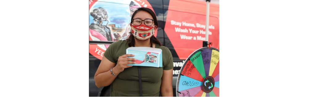 Photo courtesy of Yee Ha’ólníi DooVaccination campaign participant, Natasha Goldtooth (pictured) received a $25 gift certificate as a prize for being fully vaccinated and spinning the campaign prize wheel. Initially, the campaign began at local area flea markets and vaccination sites before becoming primarily virtual.