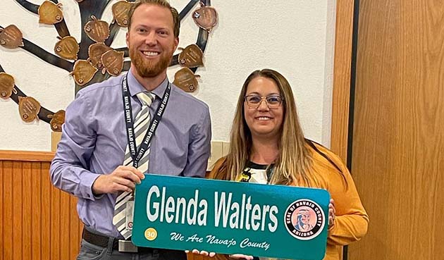 Photo by Navajo CountyGlenda Walters (right) was recognized by the Navajo County Board of Supervisors for her 30 years of service to the county. Human Resources Director Eric Scott (left) presented her with the traditional street sign.