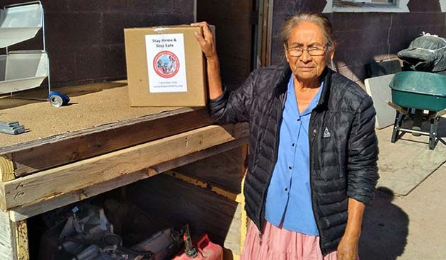 Photo courtesy of Yee Ha’ólníi DooAn elder Navajo woman receives an isolation kit as part of the Delta Relief Program to help prevent the spread of coronavirus within her community.
