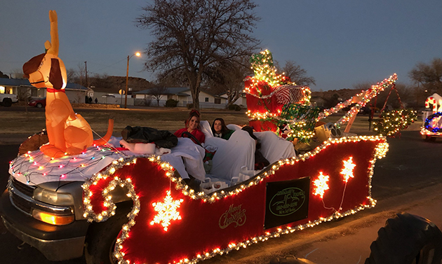 Photo by Allen MitchellThe Best Overall Award went to Mitchell’s Towing for the elaborate sleigh built to accommodate not only the Grinch but Becky Slade as Cindy Lou Who (left) and passengers Sasha Baca (right) and Jim Mitchell. The float only made it through half the parade but luckily made it past the judges before engine trouble forced it out of the lineup. Also pictured (inset) are owner Allen Mitchell, Becky Slade and their son Jim Mitchell.