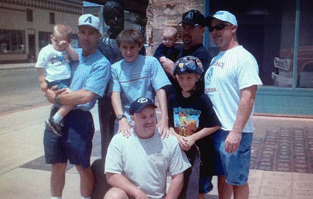 Photo courtesy of Adair family/Photo by L. ParsonsThe Adair family came back to the Corner in Winslow last weekend to recreate one of their favorite family memories. Pictured are (front) Dan, (second row, left to right) Hayden, Delbert, Tyler, Sean, Dave, (back row) Zachary and Darrell Adair. Dan Adair said, “We took that first photo almost 19 years ago when we passed through Winslow on our way to a family reunion in Pinetop-Lakeside. My three brothers and I have always wanted to do a new photograph with our four sons in the exact pose.” The first photo was taken in 2003.