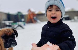 Photo by Corrina SmithTwo-year-old Mason Smith of Winslow tried out snow for the first time last week as his best friend, his dog Lola, looked on. The area was hit with significant snowfall last week bringing much needed moisture to the region.