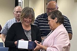Photo courtesy of Northland Pioneer CollegeColleen Readel (left) accepts the Crystal Eagle Emeritus Award from NPC's Maderia Ellison (right).