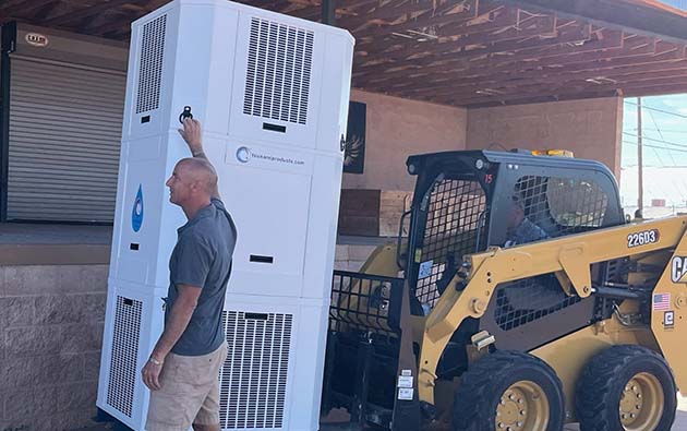 Photos by L. ParsonsPresident and Founder of Tsunami Products Kevin Conlin set up his atmospheric water generator at the Winslow Chamber of Commerce to demonstrate its effectiveness to meeting attendees last week. Winslow Mayor Roberta “Birdie” Cano sampled water produced by the generator and found it delicious.