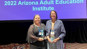 Northland Pioneer College educators Nichole Hendricks (left) and Shandiin Deputee (right) accept awards during the 2022 Adult Education Institute’s Annual Awards Ceremony.