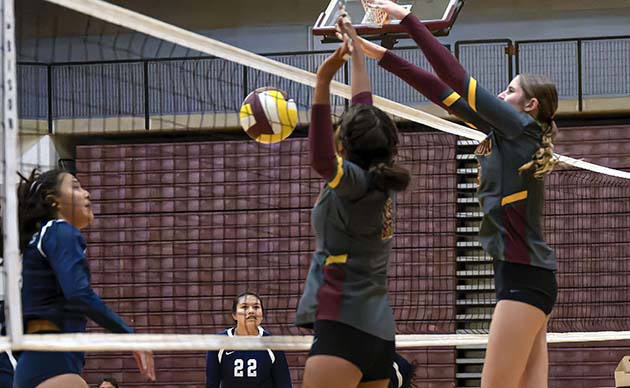 Photo by Richard LarsonLady Dogs beat Window Rock last week in four sets to win the match. Shaelene Singer No. 11 and No. 3 Brynlee Barris block the volleyball at the net in an outstanding defensive effort.