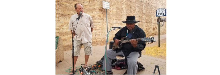 Photo by L. ParsonsLongtime Winslow resident and Arizona Blues Hall of Fame Inductee Tommy Dukes (right) played a few songs on the corner last week as he received his brick from the Standin’ On the Corner Foundation that will be placed along with other bricks as part of a paved memorial at the Standin' on the Corner Park. Foundation member Greg Hackler (left) introduced Dukes and thanked him for his continued contributions to Winslow.