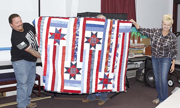 Photos by Linda KorWilliam “Lucky” Warner (left) was presented with a quilt created by Rozella Leonard of Winslow and Judee Macaulay of Snowflake. Presenting the quilt was quilt guild member Cheryl Martin (right).
