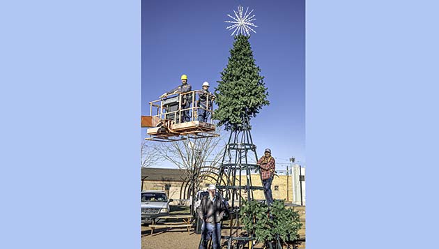 Photo by Richard LarsonA crew with the City of Winslow was busy last week setting up the city Christmas tree on Second Street for residents and visitors to enjoy. An official community tree lighting was held on Saturday.