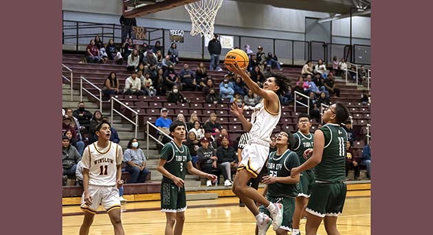 Photo by Richard LarsonThe Winslow Bulldogs won by just one point when they went up against the Tuba City Warriors on Nov. 22, with a final score of 62-61. Here Kasey Monroe goes for the shot in a very exciting game.