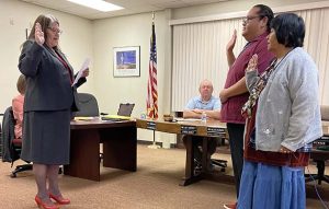 Photo by Shawn WhiteWilcox (center) and Dodie Montoya (right) take their oath of office after being elected and reelected to WUSD School Board. The oath was administered by Superintendent Connie Gover (left).