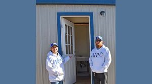 Photo courtesy of Northland Pioneer CollegeCecilia Larsen (left) and Dale Click (right) are pleased to have been involved in the completion of temporary homes for peace officers in training at NATC.