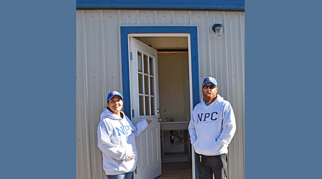 Photo courtesy of Northland Pioneer CollegeCecilia Larsen (left) and Dale Click (right) are pleased to have been involved in the completion of temporary homes for peace officers in training at NATC.