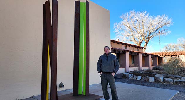 Photo by Dan LutzickArtist Mark Knutson stands with his sculpture “Parallax” after its installation at the Winslow Arts Trust Museum.