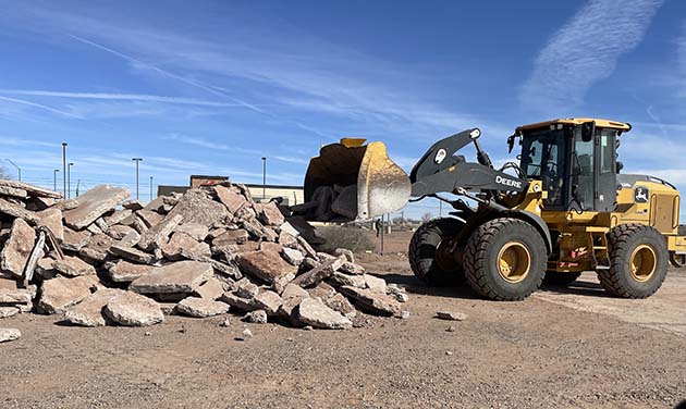 Photo by Linda KorLast Friday, city administrator Michael Young used a city wheel loader to remove concrete for a private business on Navajo Blvd. on his day off.