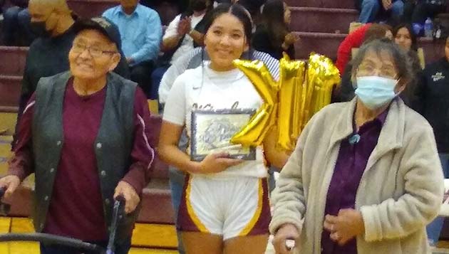 Photo by K. ConnerWHS basketball player Jaci Gonnie (center) was honored at half-time for making 1,000 points as a player. By her side were her great-grandparents Patsy Singer (right) and Charley Singer (left).