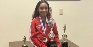 Photo by Shawn WhiteCinniah Echoles poses with all of her trophies and medals she earned at the Elk’s Hoop Shoot competition.