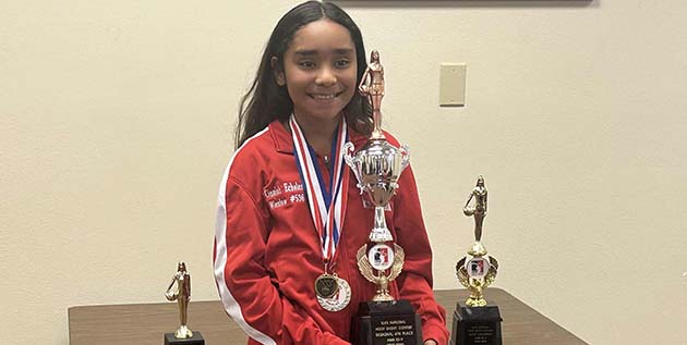 Photo by Shawn WhiteCinniah Echoles poses with all of her trophies and medals she earned at the Elk’s Hoop Shoot competition.