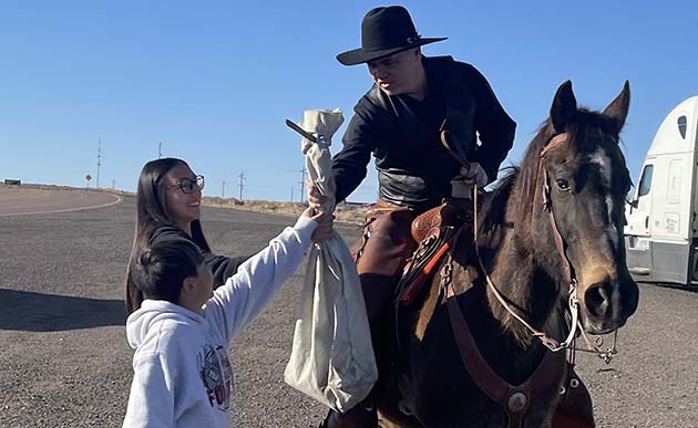 Photos by Linda KorEnrique Pacheco (right), the son of Walter Pacheco one of the Clear Creek Cowboys who passed away last year, was the first rider to head out on the Territorial Road Pony Express. Presenting the mail were Walter Pacheco’s grandchildren, Sasha Medina and Juan Pacheco, all of whom were sworn in as mail carriers by Postmaster Arthur Gonzales in order to handle the mail.