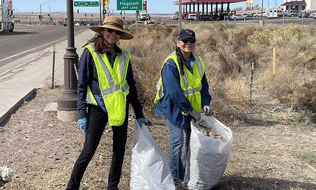 Photo by Linda KorThe Holbrook Chamber of Commerce hosted a clean-up day sponsored by the City of Holbrook, Arizona Public Service and Waste Management. Mary Bradley (left) and Laura Boyd (right) were two of many residents walking the streets of the city, cleaning up as they went along.