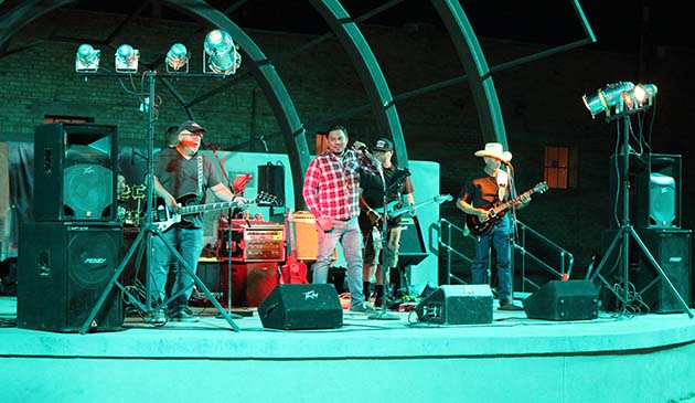 Photo by Shawn WhitePerfect storm performs under the new Route 66 Plaza lights as part of Food Truck Friday in Winslow. The band includes lead singer Jose Aguilera Jr., Mike Leary on lead guitar and vocals, Mike Duran and Andy Lowery on rhythm guitar, Ernie Cano on bass, and Omar Galvan on drums.