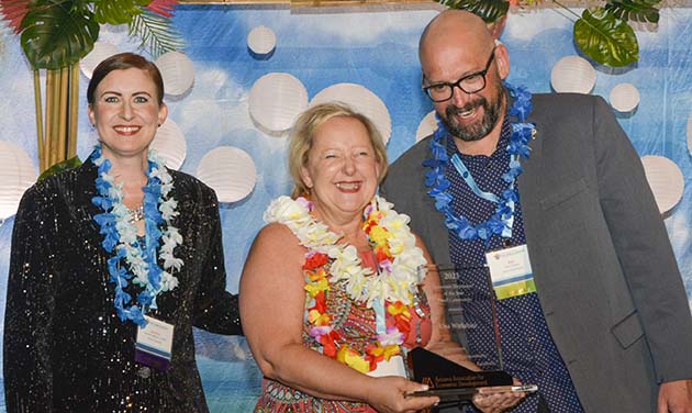 Photo courtesy of MadridMediaUna Wirkebau (center) accepts the 2023 EDDE Award as Economic Developer of the Year for a Small Community from Jeanine Jerkovic (left) with the City of Surprise and Ken Chapa (right) with the City of Avondale.