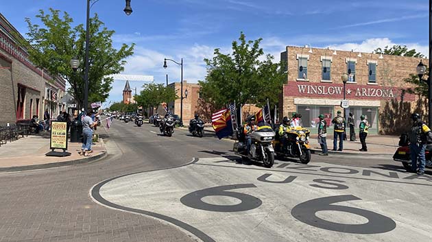Photos by Linda Kor and Lynn HuenemannRun for the Wall riders made their annual trek to the Vietnam Veterans Memorial Wall in Washington, D.C., last week, traveling through northeastern Arizona last Thursday. Riders first went through downtown Winslow, then were greeted by the Joseph City Volunteer Fire Department and Arizona Public Service Fire Brigade members who displayed a giant flag over the interstate in Joseph City. Riders then arrived in Holbrook, where they drove past schools with excited children waving flags and were treated to a delicious meal by the American Legion Auxiliary.