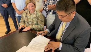 Photo by Robert DeDeauxArmy Corps of Engineers Colonel Julie Balten (left) and Navajo County District II Supervisor Alberto Peshlakai sign the Pre-Construction, Engineering, and Design Agreement at the historic Hubbell Building in Winslow that will allow construction to begin on the Winslow Levee.