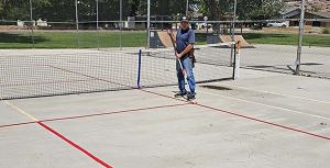 Photo by Randy SullivanThe City of Holbrook has added a pickleball court to its amenities at Hunt Park for residents to enjoy. City employee Tim Kelley (pictured) was working last week to provide the finishing touches. The court will replace one of the tennis courts at the park.