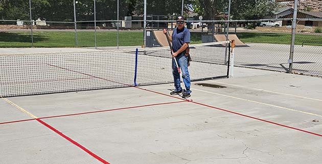 Photo by Randy SullivanThe City of Holbrook has added a pickleball court to its amenities at Hunt Park for residents to enjoy. City employee Tim Kelley (pictured) was working last week to provide the finishing touches. The court will replace one of the tennis courts at the park.