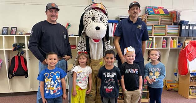 Photo by Nicole YoungHolbrook Volunteer Fire Department firefighters Jacob Baker (left) and Michael Young (right), along with Sparky (center) paid a visit to Park and Hulet elementary schools in Holbrook on Thursday, Oct. 19, including these students from the pre-school at Park Elementary School, providing a slide show for students on fire prevention as Part of Fire Prevention Week.