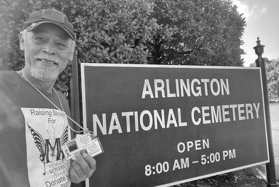 Hogan Hilling standing in front of Arlington National Cemetery on his journey across America to spread awareness about Moms Against Veteran Suicide. Photo courtesy of Hogan Hilling